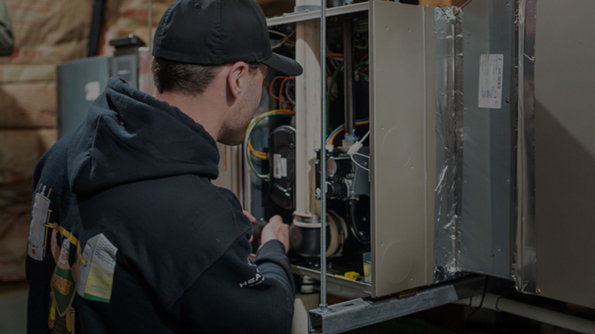 Technician servicing a furnace in Bend home.
