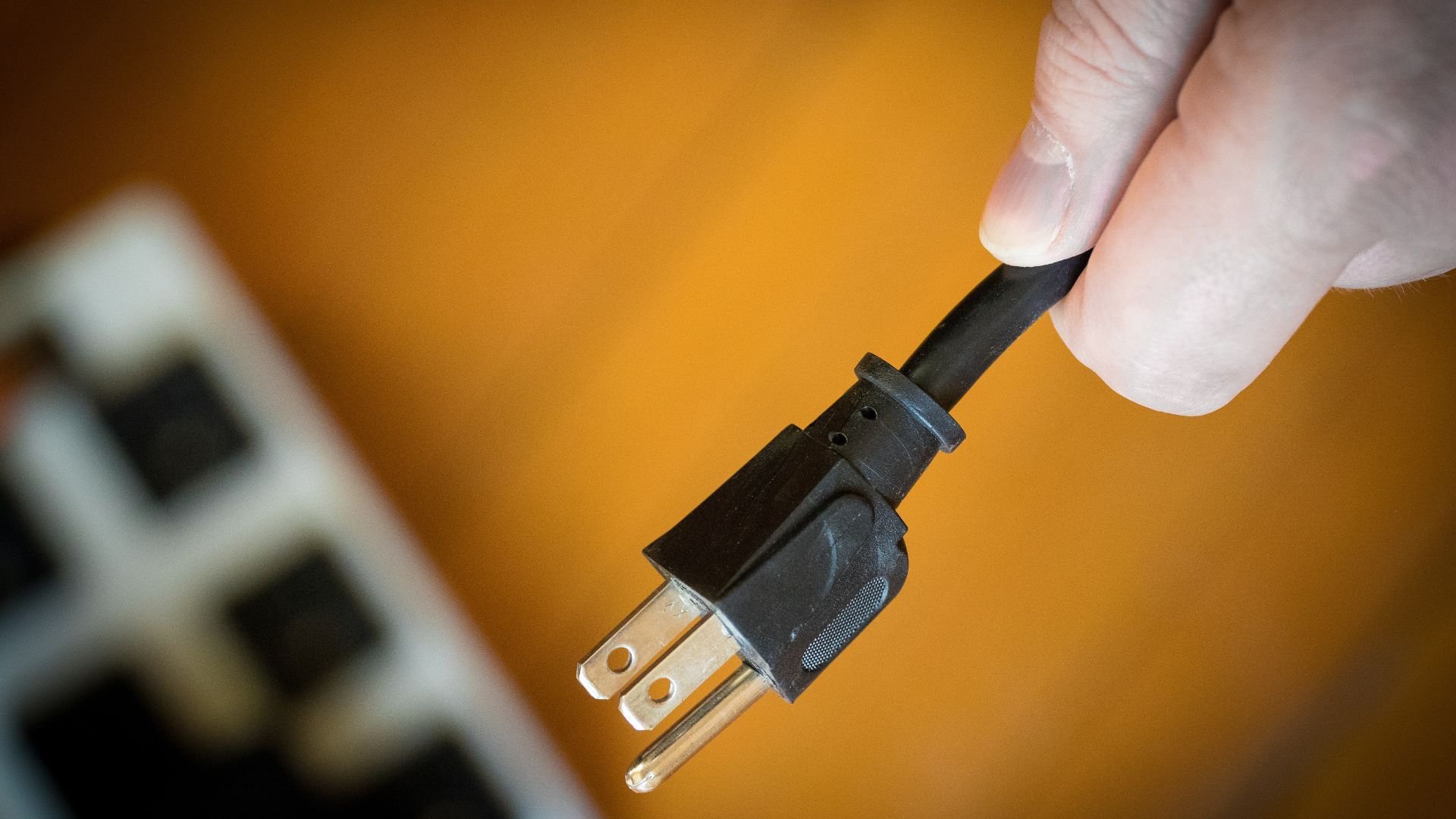 Electrician testing a newly installed surge protector in a Central Oregon home.