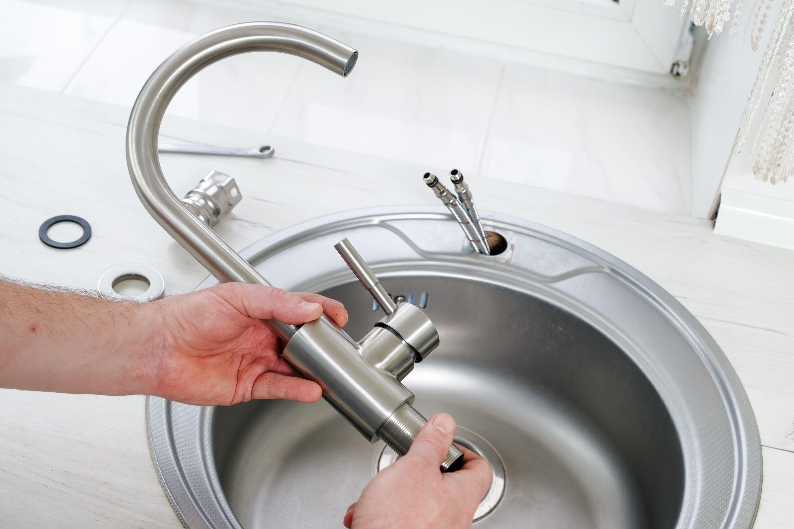 Plumber works on seasonal plumbing maintenance