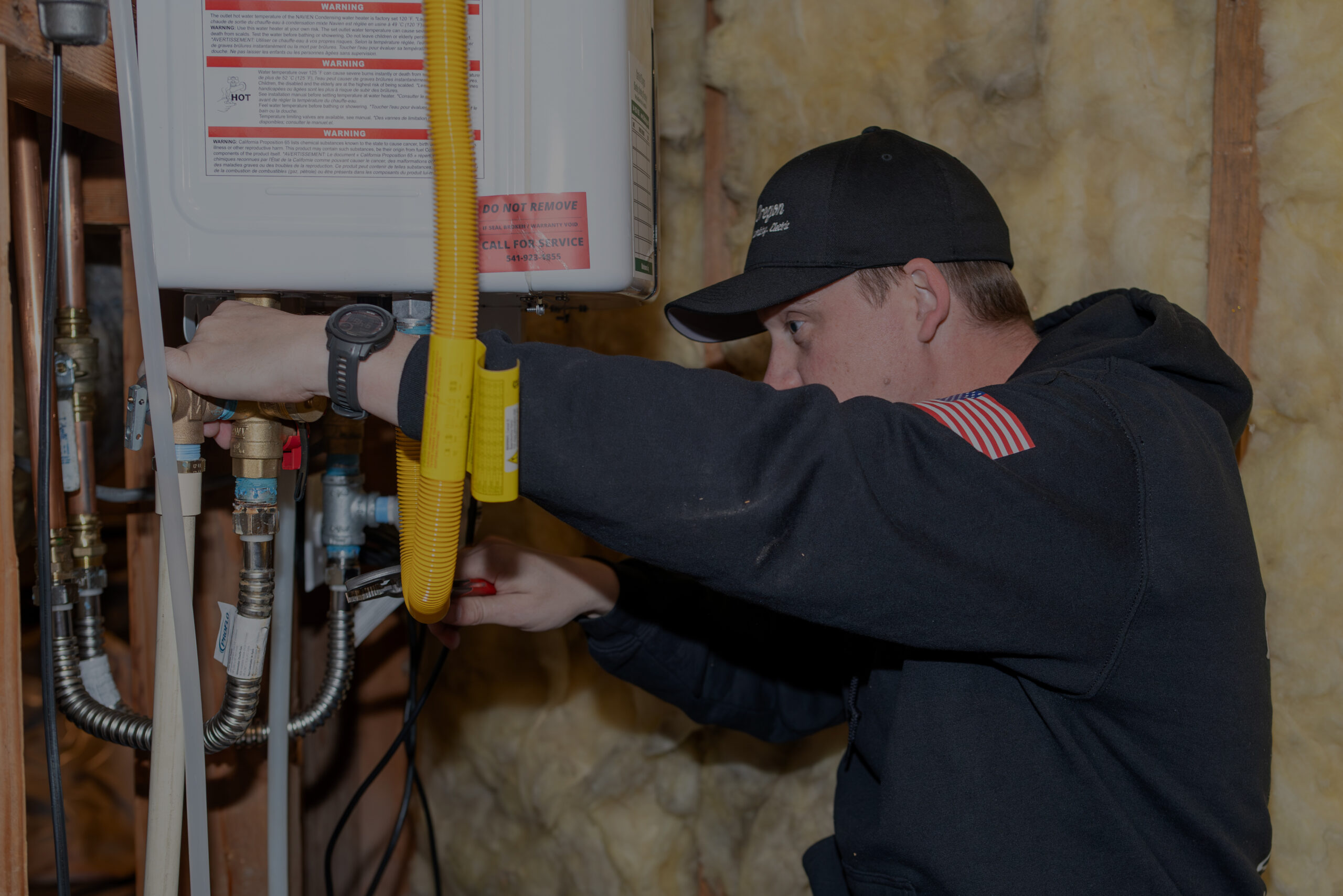 Technician servicing a tankless water heater.