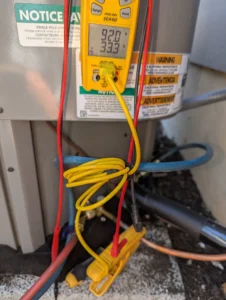 Technician inspecting outdoor unit after compressor electrical failure during an emergency AC repair in Bend, OR,