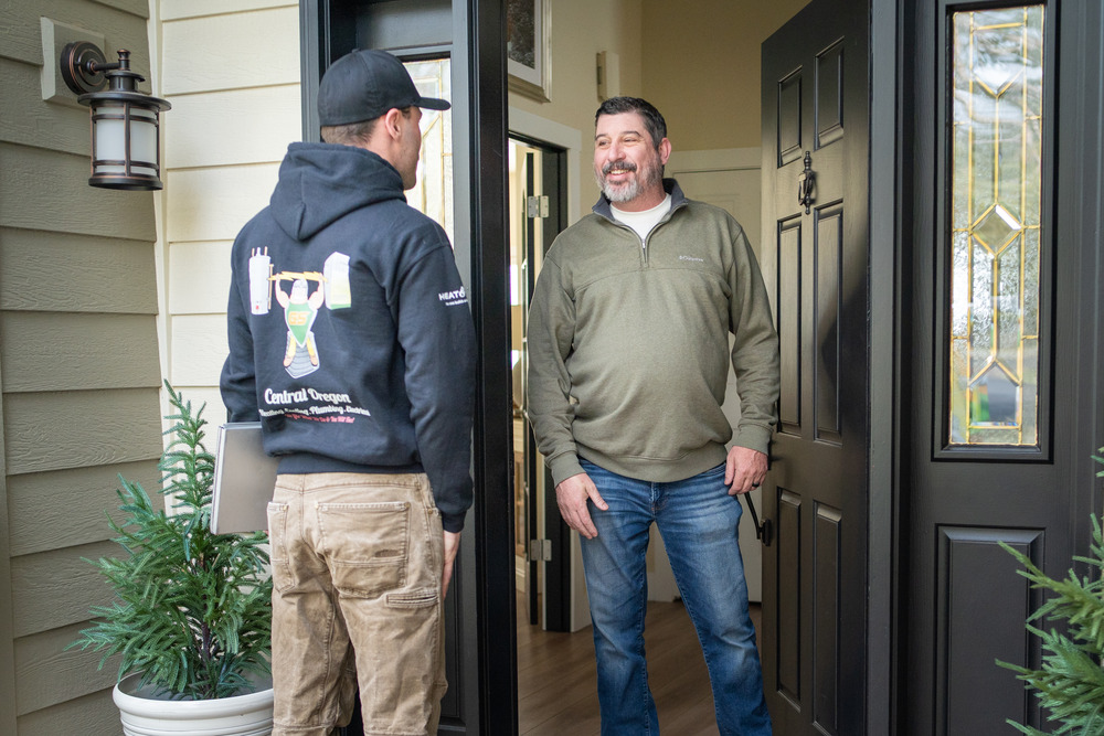 HVAC technician speaking to the homeowner