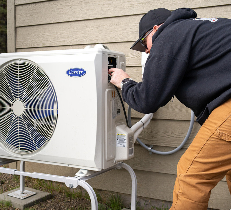 HVAC technician repairing an HVAC system.