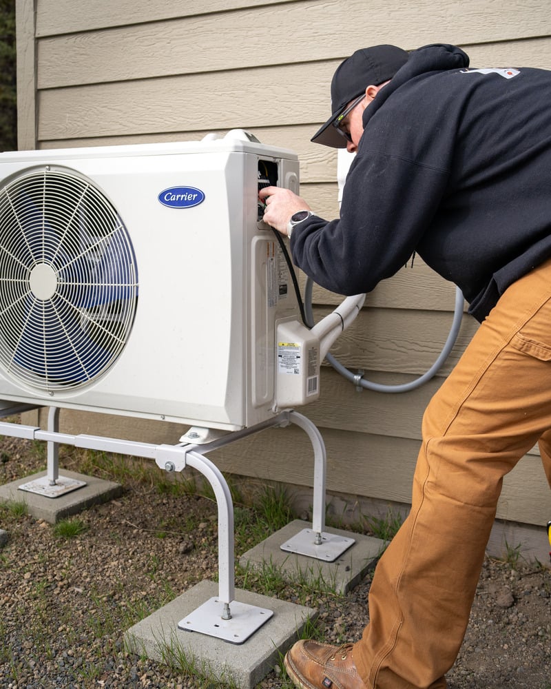 HVAC technician repairing an HVAC system.