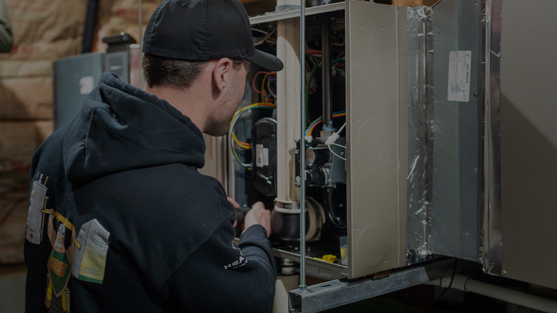 Technician servicing a furnace in Bend home.