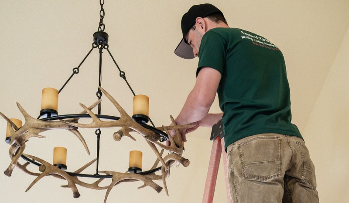 Image of an electrician in Denver rewiring a customers home